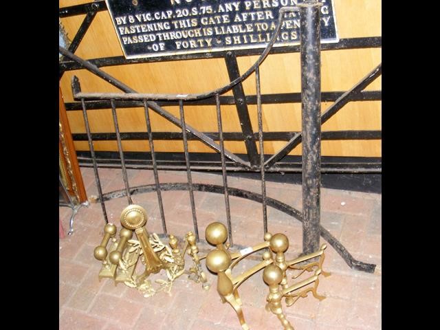 An old wrought iron gate, together with brass fire