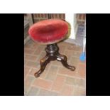 An antique revolving piano stool