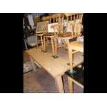 An oak dining table sporting wide leg support - wi