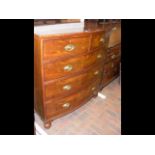 An antique bow fronted chest of drawers