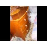 An inlaid bow front chest of drawers