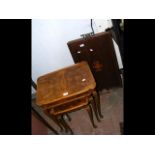 A nest of three walnut occasional tables, together