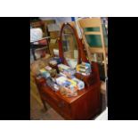 A three tiered dressing table with oval mirror