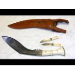 An old kukri with ivory grip and leather scabbard