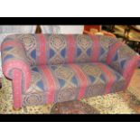 A Chesterfield settee upholstered in decorative re