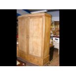 A serpentine fronted antique wardrobe with drawers