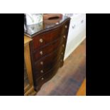 A mahogany bow fronted chest of drawers sporting s