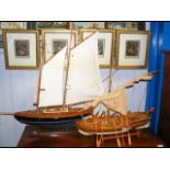 A wooden model boat together with yacht