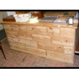 A multi-drawer pine chest - 186cm long