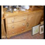 An antique pine sideboard with drawers and cupboar