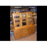 An Ercol 'Golden Dawn' display cabinet with drawer