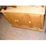 A pine three door cupboard