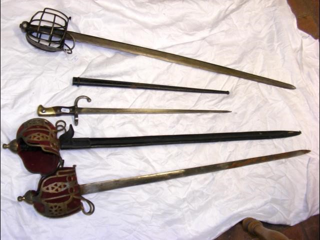 An old sword with metal hand guard, together with