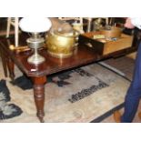 A Victorian extending dining table with two leaves