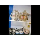 Two shelves of collectable ceramic ware, tea pots e