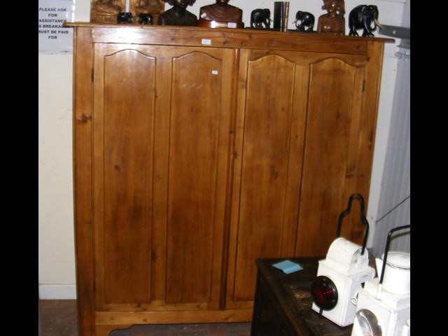A 150cm wide pine cupboard