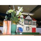 A wooden dolls house with two boxes of interior pi