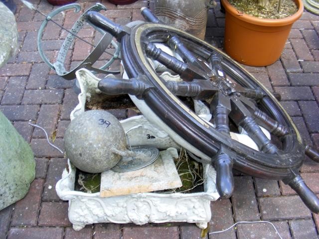 A ship's wheel, garden weather-vane, life ring, et