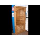 A 19th century pine barrel back shelf and cupboard