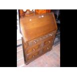 An Ipswich carved oak bureau with fitted interior