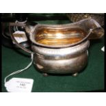 A silver cream jug