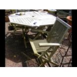 A garden table together with four folding chairs