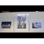 Three photographic prints of city scenes in white