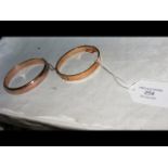 A gold bangle in presentation case and one other