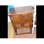 A stained oak pot cupboard with gothic embelishmen