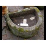 An antique semi-circular garden trough - 68cm x 50
