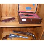 An antique flintlock pistol and revolver cap gun,