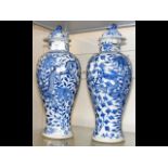 A pair of oriental blue and white dragon vases wit