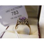 An amethyst and diamond ring in gold setting