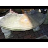 A cast curved garden concrete bench