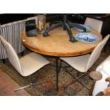A circular pine industrial style dining table with