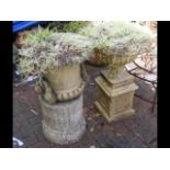 Two garden urns on plinths