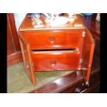 A two drawer miniature chest with doors to the fro