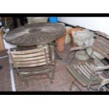 A circular wooden and wrought iron table - for res