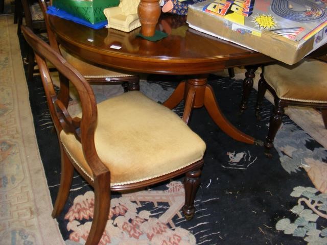 An extending reproduction mahogany dining table wi
