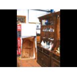 An open-shelved dresser with panelled back - width