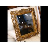 A gilt framed wall mirror