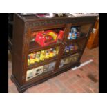 A dark wood display cabinet with glazed doors and