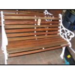 A cast iron ended bench, re-slatted in teak with b