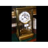 A 30cm high four glass mantel clock with visible e