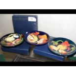 Three boxed Moorcroft pin dishes