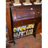 A stained oak bureau with beading detail to drop d