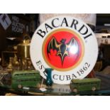 A circular enamel Bacardi advertising sign togethe