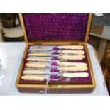 A cased set of 12 place setting knife and forks