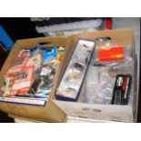 A box containing model train accessories and one o