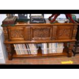 An antique carved oak sideboard, featuring